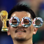 A-fan-wears-handmade-glasses-referring-to-the-1-000-World-Cup-matches-before-the-start-of-the-2026-World-Cup-Group-F-football-match-between-Tunisia-and-Japan